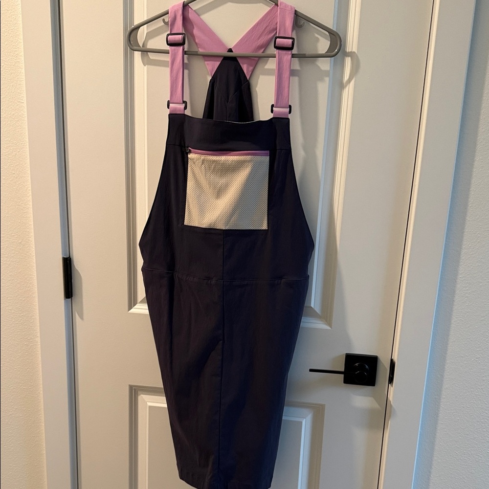 cotopaxi Purple Bib Overalls with Pink Straps and Cream Pocket
NWOT